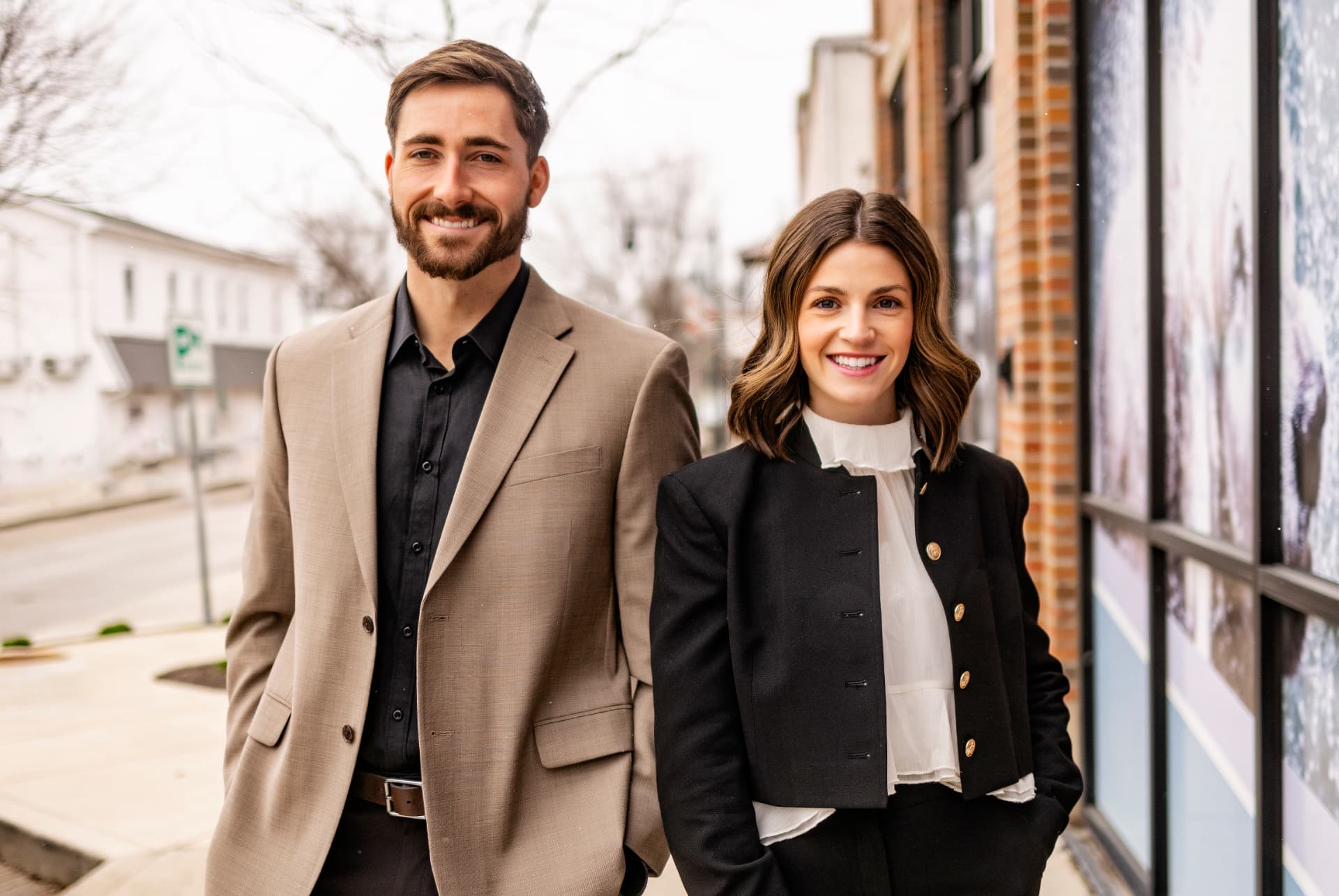 Zach Archer and Sophia of Archer Home Team standing together on a downtown sidewalk in Hendricks County, Indiana